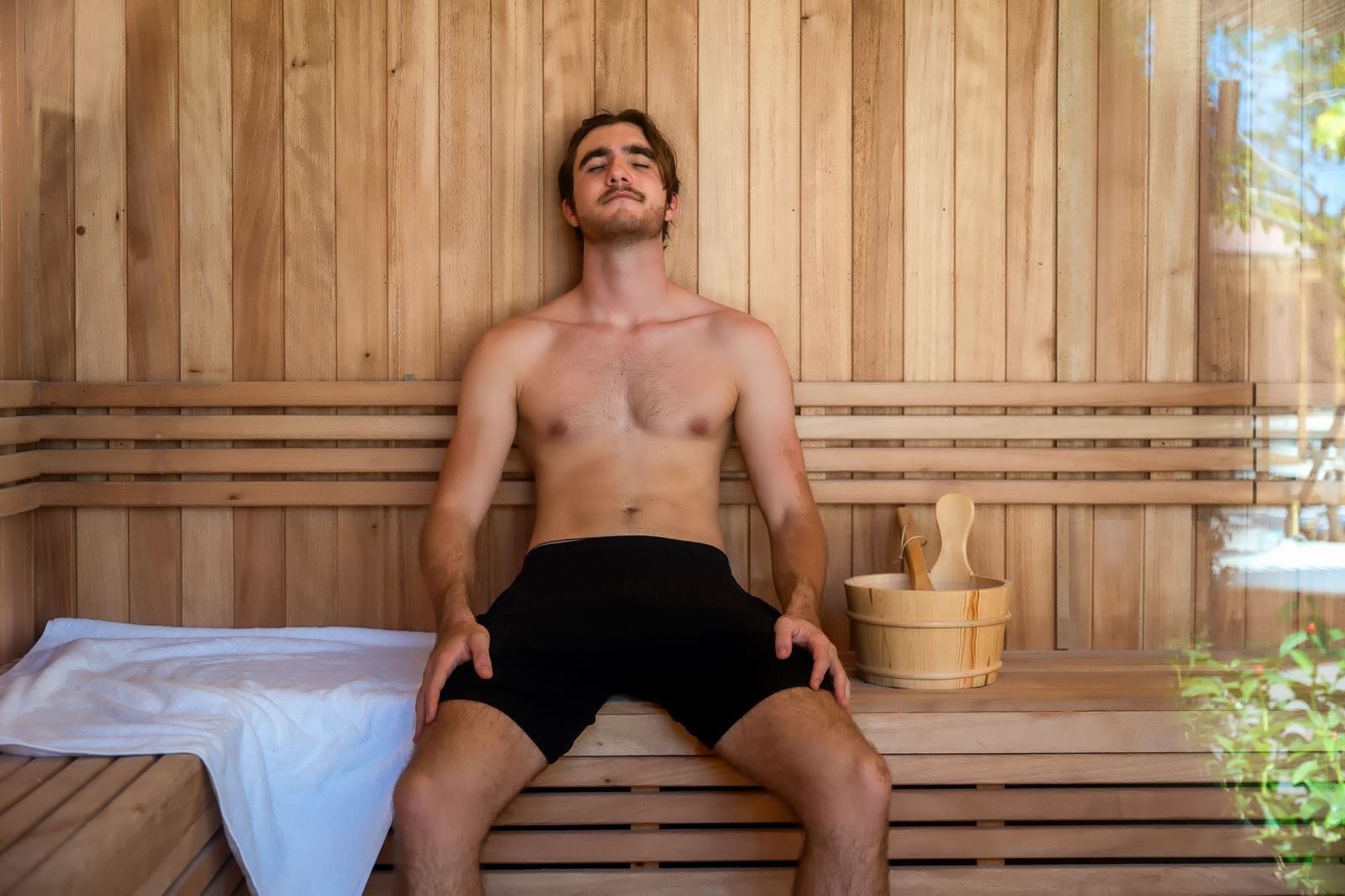 Guest relaxing in the Finnish sauna at Breathe Sanctuary, Phuket