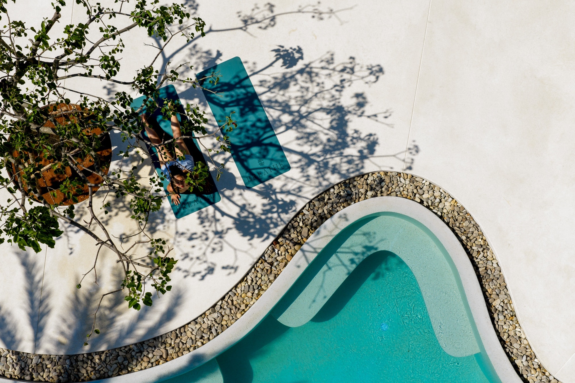 Guests relaxing by the pool at Breathe Phuket